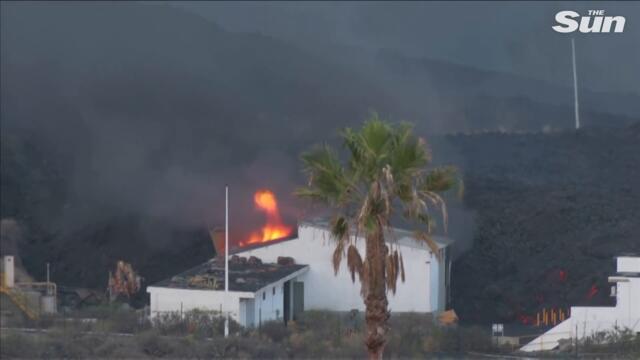 Drone view of La Palma house engulfed by lava & hot boulders