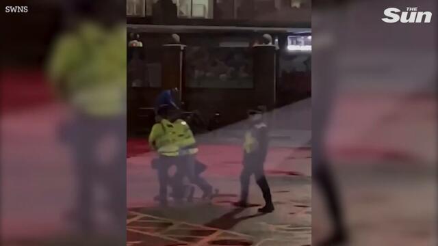 Shocking moment cop ‘knocks out’ Charlton fan after violent clashes outside Old Trafford stadium