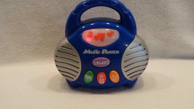 Musical light up player boom box toy featuring piano, violin and drums