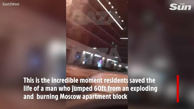 Heart-stopping moment man leaps from exploding building as people try to catch him with blanket