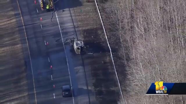 Van fire spreads to woods, shuts I-97